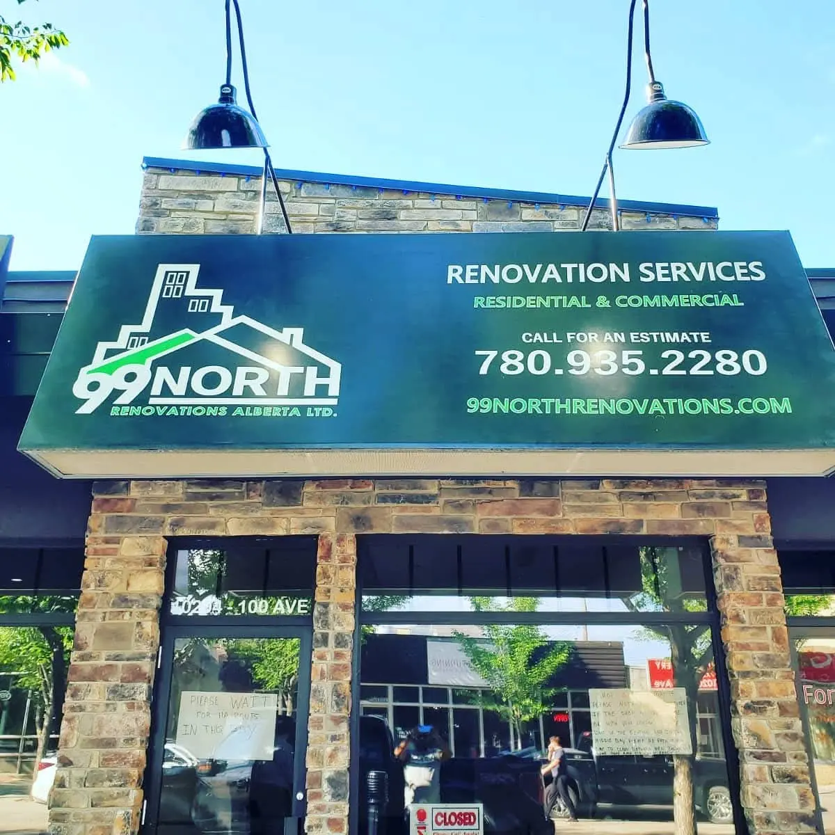 99 North Renovations green awning with logo, phone number and website