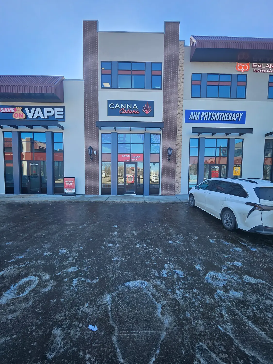 Retail plaza with Canna Cabana, Save On Vape and AIM Physiotherapy storefront signs